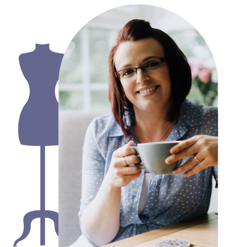 An image of Rebecca Cole, the author, holding a teacup and smiling at the camera. She is wearing a blue polka dot shirt, with short red hair and thin framed glasses.